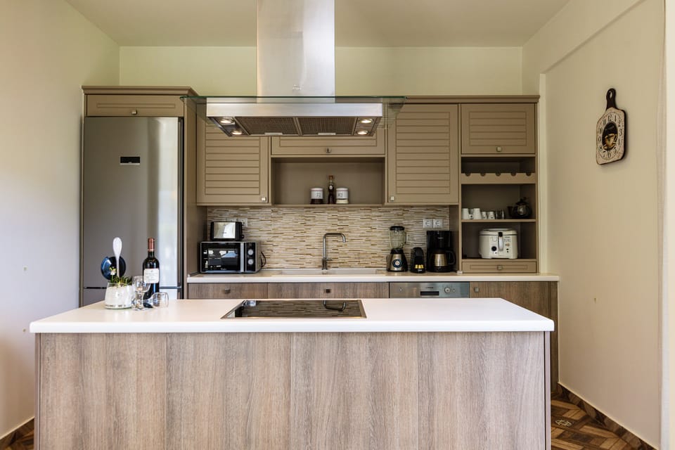 Fully equipped kitchen featuring a microwave, toaster, oven and refrigerator.