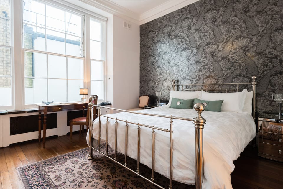 Designer wallpaper throughout the house. This is the Silver Peacock room. 