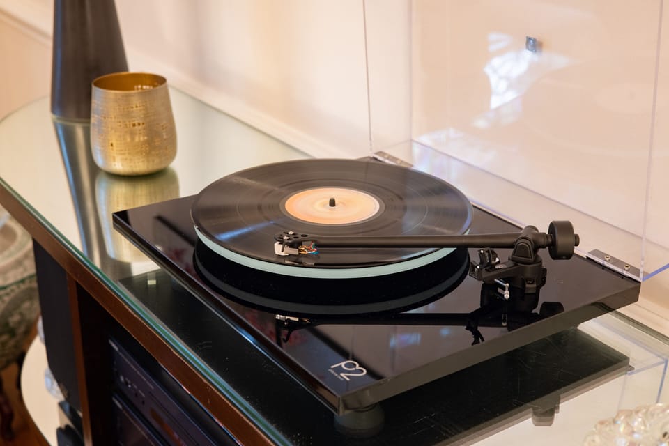 Rega Planar turntable. Some vinyl in the cabinet. 