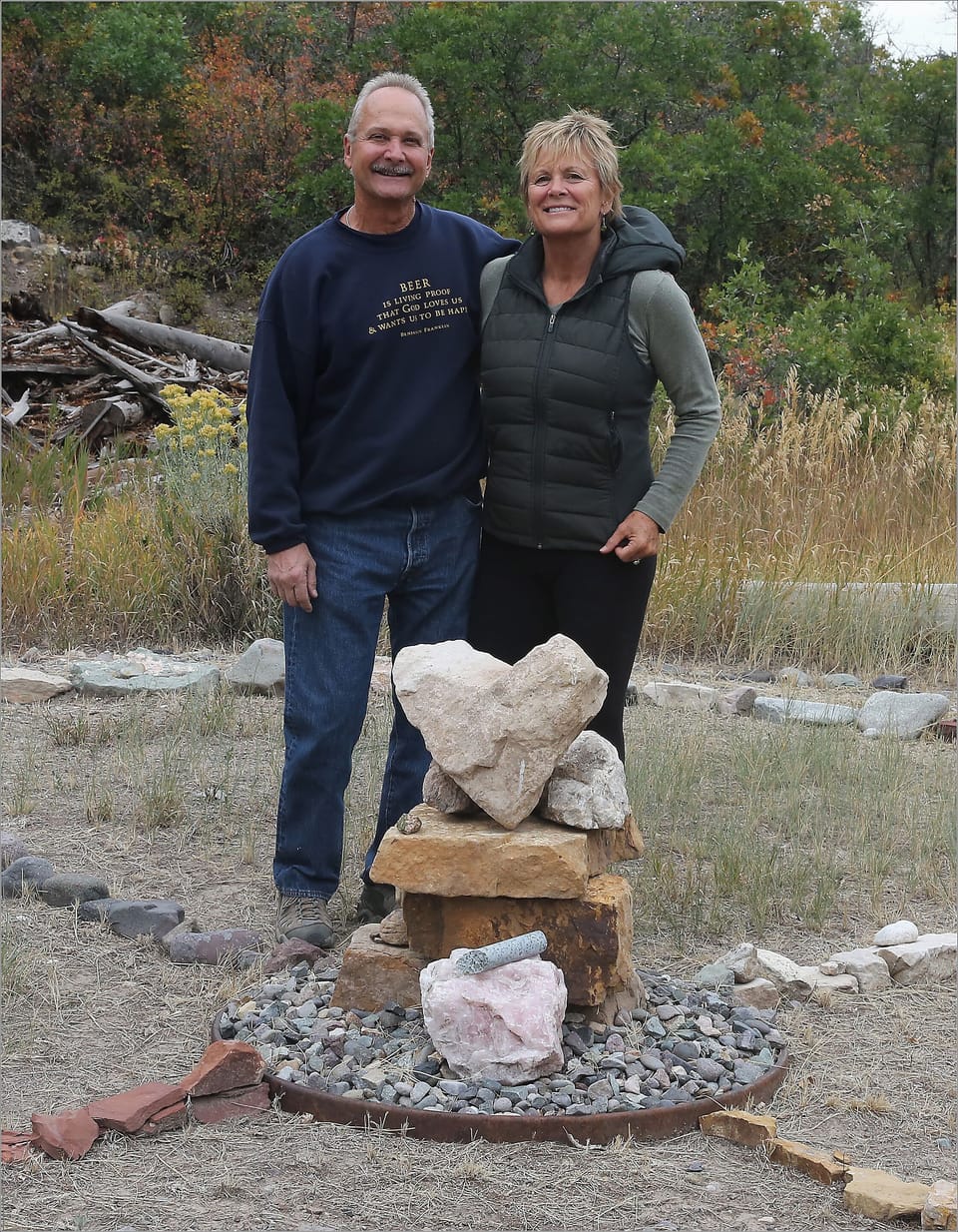 Pat and Teri (hosts) standing at the medicine wheel on the property