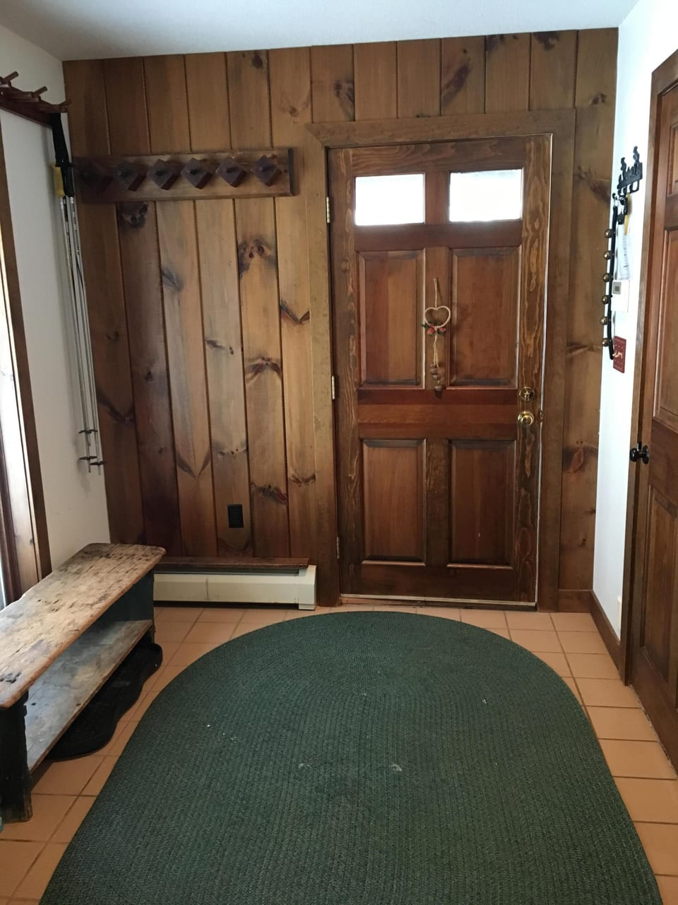 Mudroom with plenty of spots to hang skis, pole, and jackets