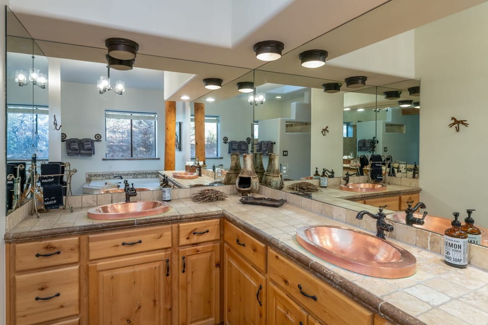 The primary bathroom features double sinks and an alluring garden tub.