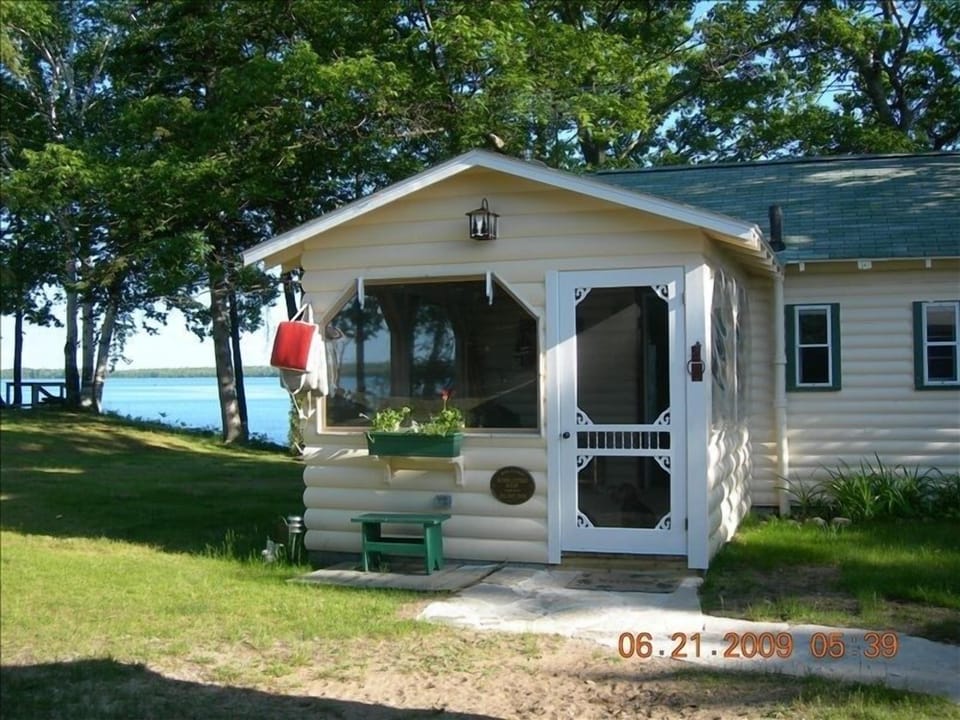 Screened porch with pull down shades for privacy