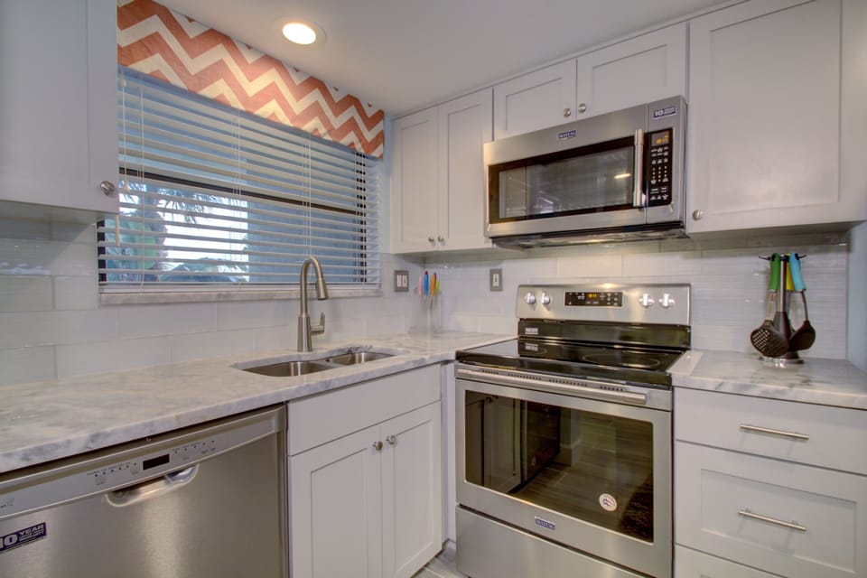 New granite counter tops, backsplash, new sink/faucet, water purifier & disposal