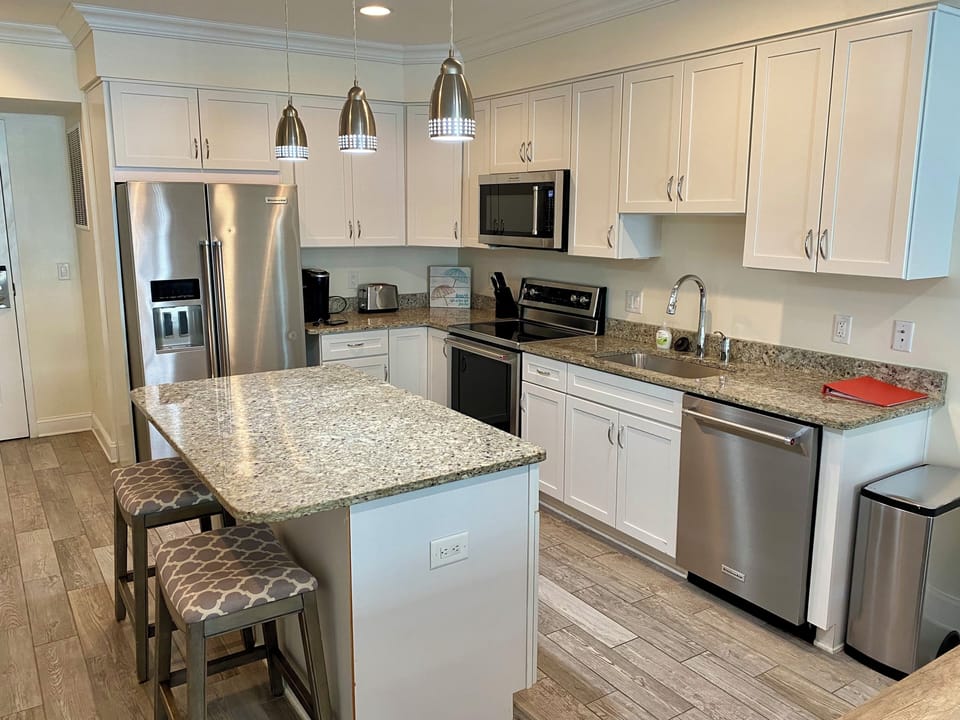 Updated kitchen with extra seating at island bar.