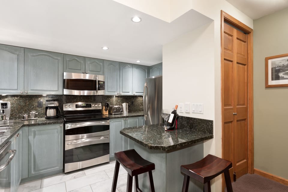 Double oven, microwave, granite countertops and stainless steel appliances