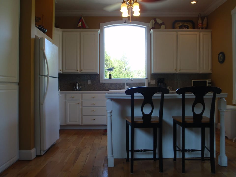 Full kitchen with coffee pot, microwave, refrigerator, range and dishwasher