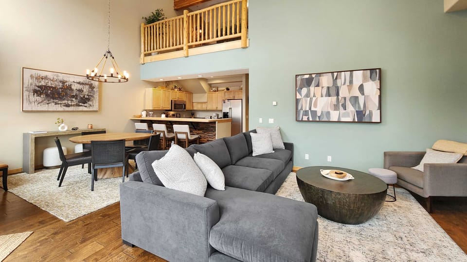A view over the shared living space where the living room, dining room, and kitchen seamlessly blended into one open area.