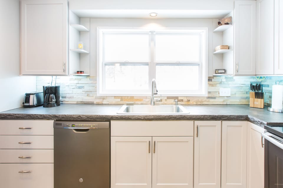 Kitchen with window facing beautiful back yard.