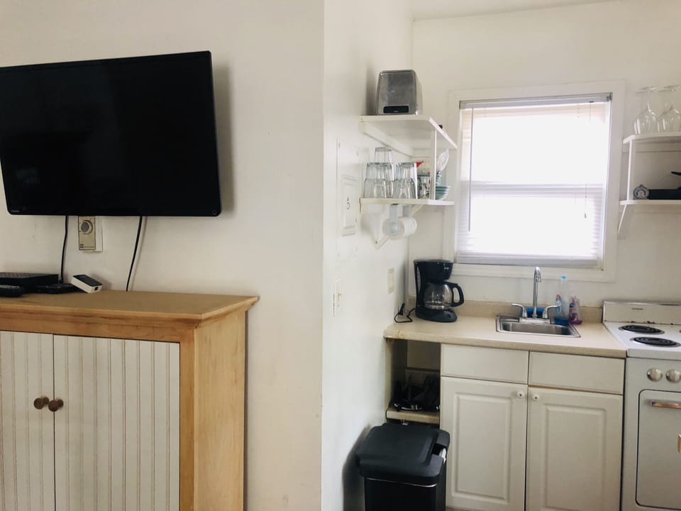 Flatscreen TV with cable, and locally crafted  shaker cabinet.