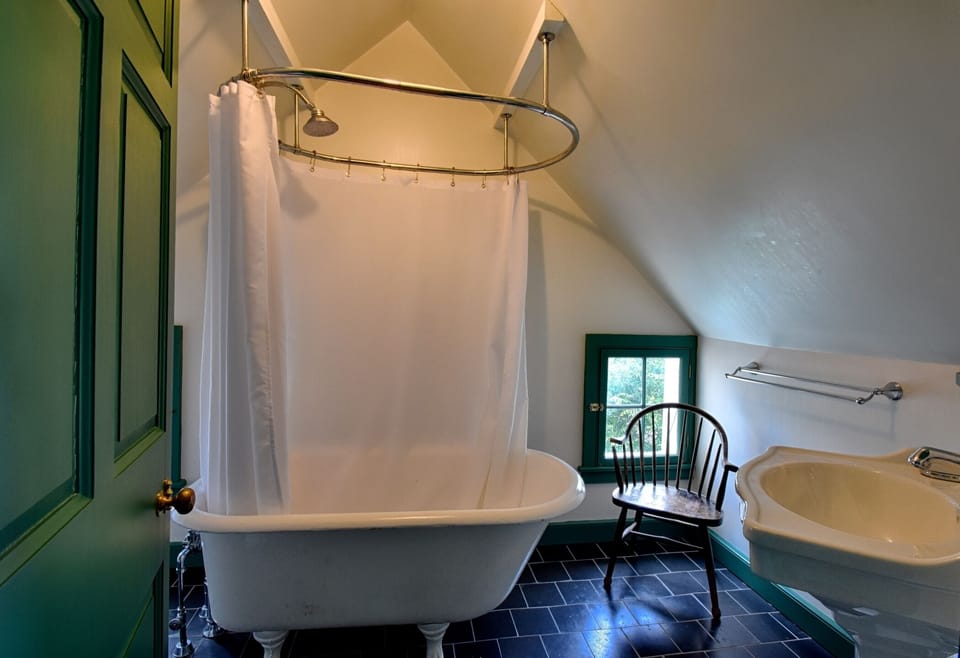 The Garrett Bedroom has a small bathroom with a claw-footed tub/shower.