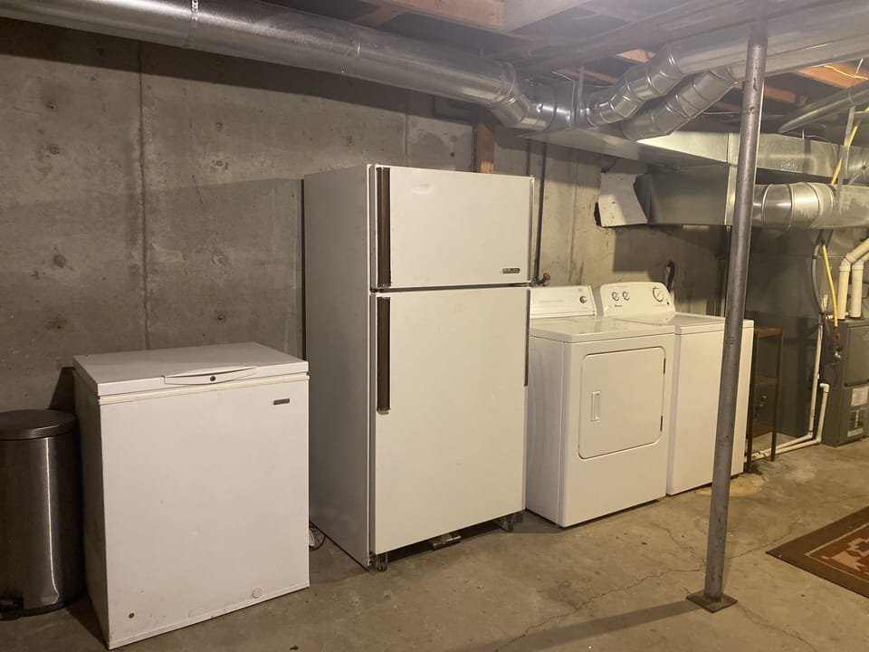 Basement has extra freezers, refrigerator and washer and dryer 