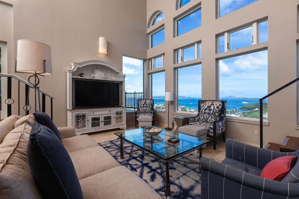Spacious living room with panoramic ocean views and cozy seating.