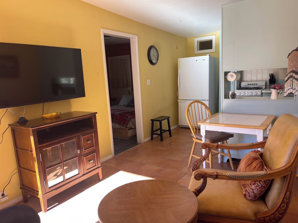 Living room with TV and the kitchen table