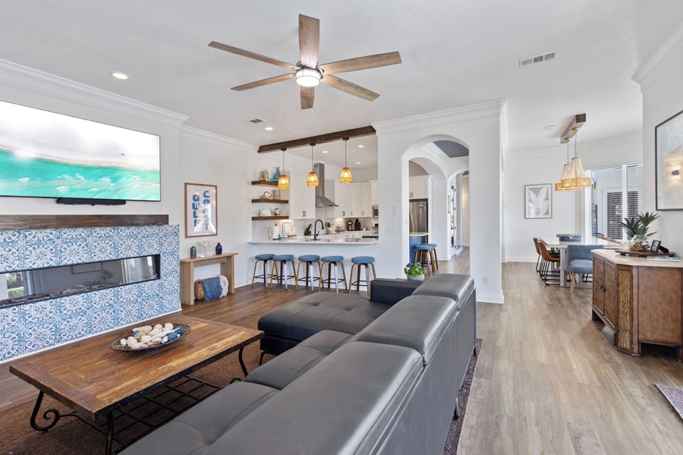 Unwind in this stunning open-concept space where coastal charm meets modern comfort, featuring your private kitchen and cozy fireplace.