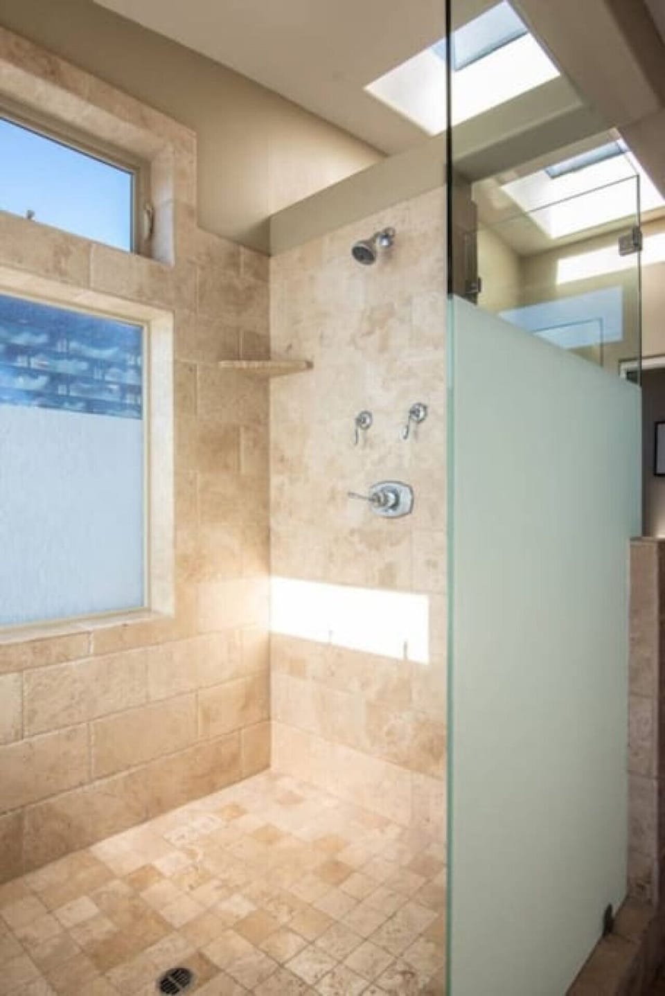 The walk in shower in the primary suite