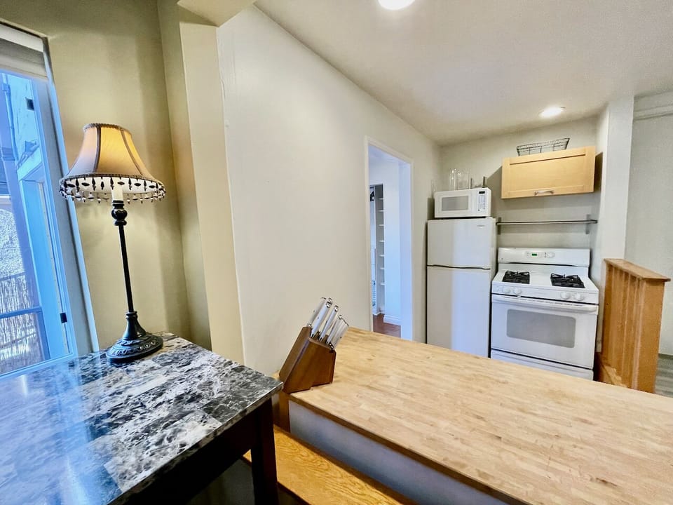The kitchen also includes a knife block and kitchen island with extra storage