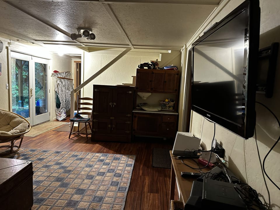 Downstairs Living room.  Games and puzzles in the chest.