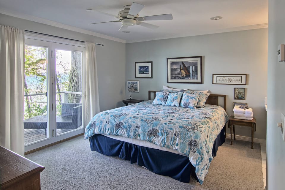 Main level master-french doors open to a private deck and water views.