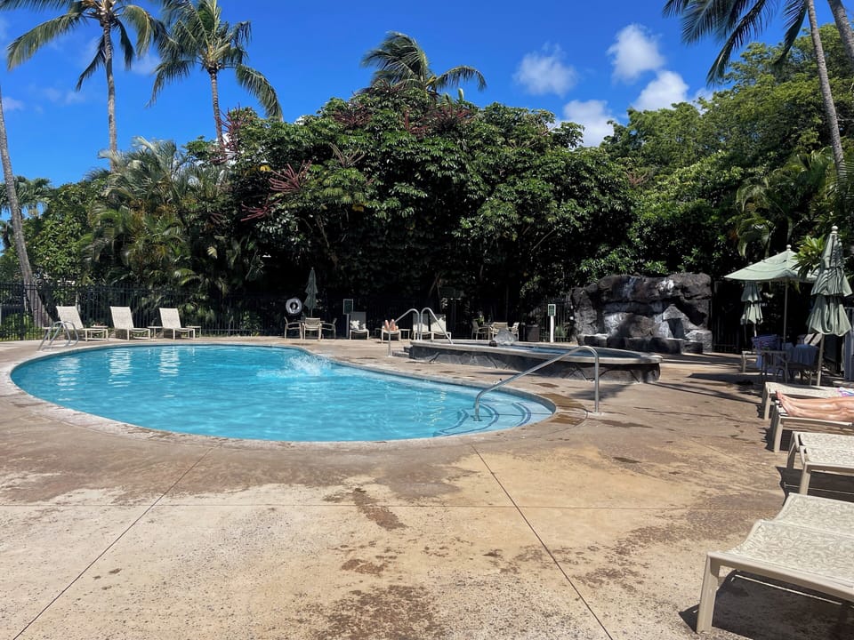 Pool and jacuzzi with lounge chairs