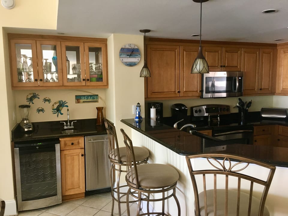 Wet bar with wine refrigerator, ice maker for coolers & cocktail/wine glasse