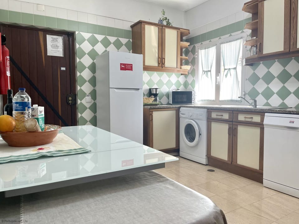 Spacious fully equipped kitchen with door to side garden & built-in BBQ.