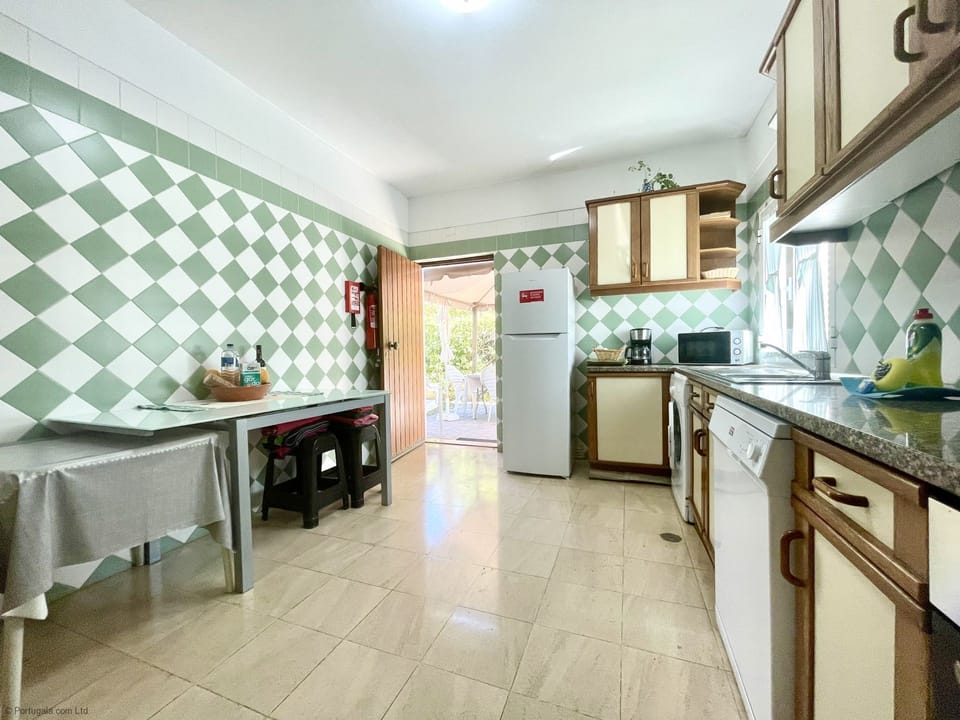 Spacious, fully equipped kitchen with door to side garden & built-in BBQ.