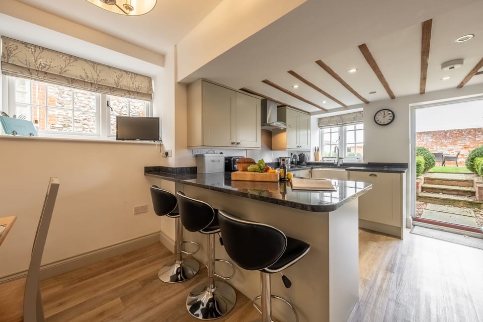 Ground floor: Open plan kitchen with a peninsular and seating for three