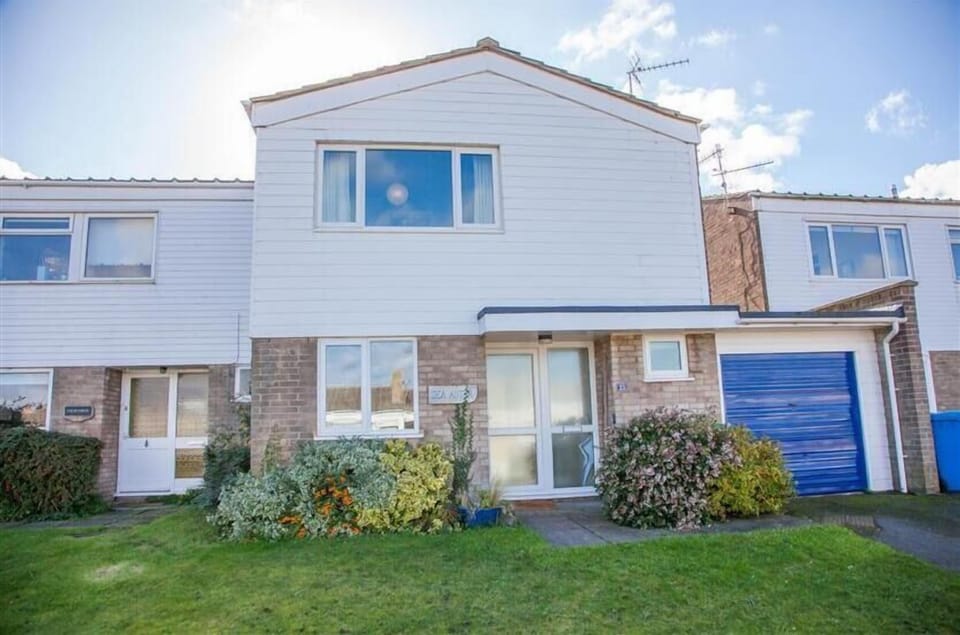 Sea Aster, Brancaster Staithe: Front elevation with use of garage for bike storage