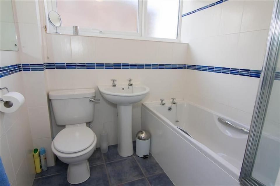 First floor: Family bathroom has bath with shower over
