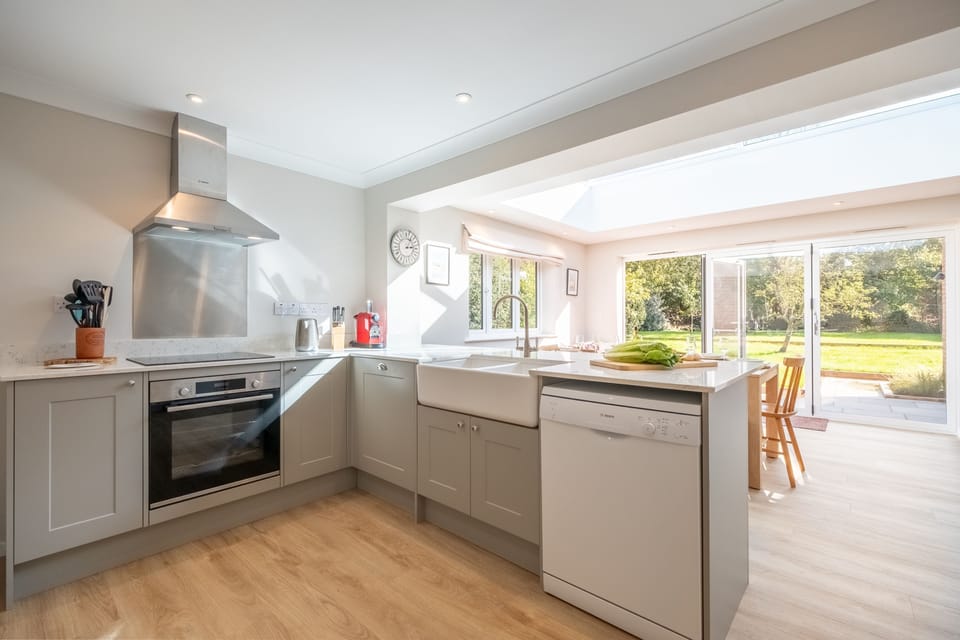 Well-equipped, modern kitchen with Belfast sink and views to garden