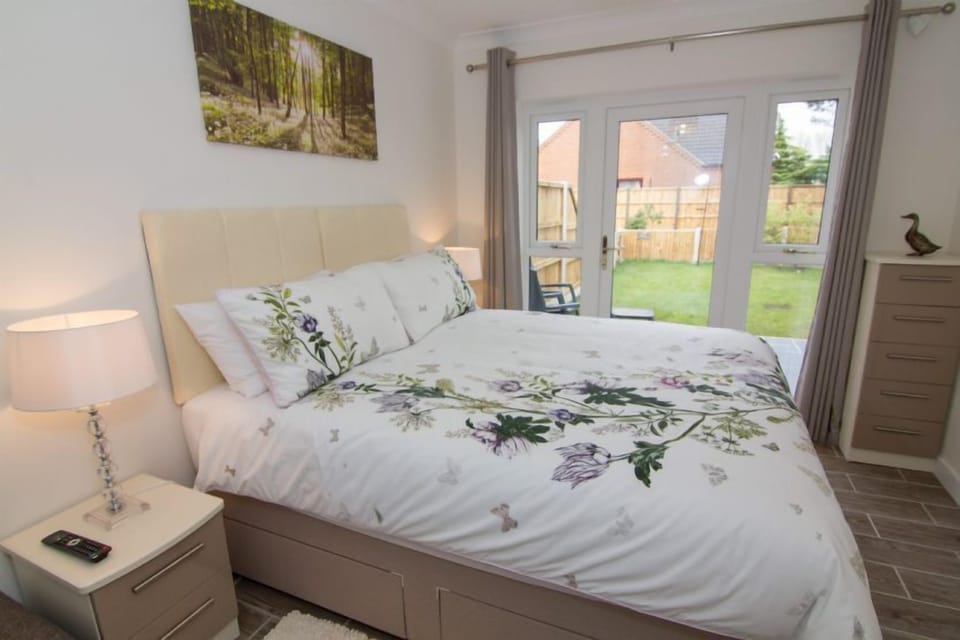 Ground floor:  King-size bedroom with glass door to enclosed rear garden
