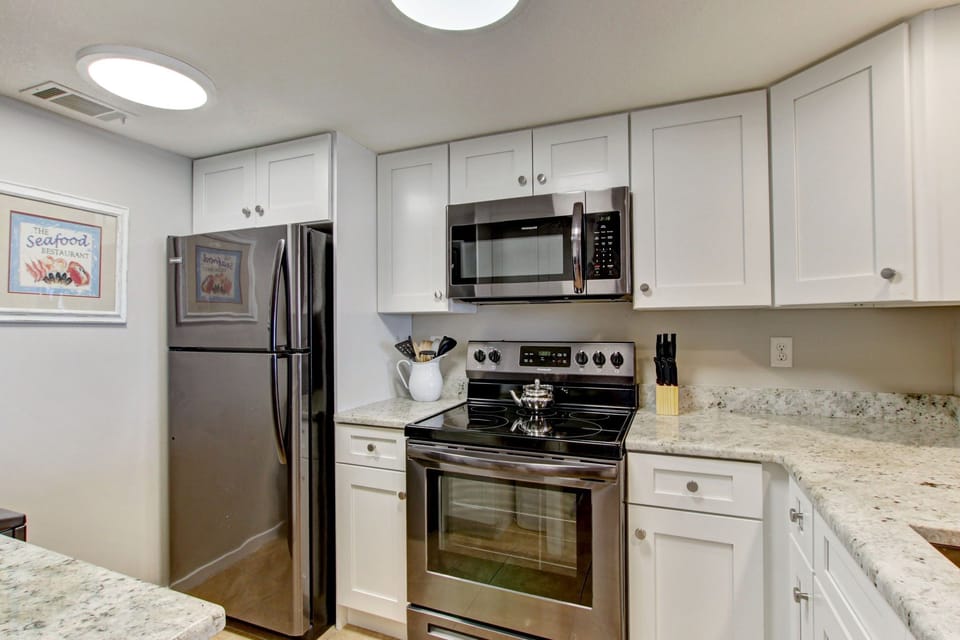 Upgraded Kitchen Featuring Granite Countertops and New Stainless Steel Appliances