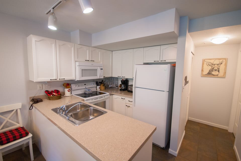 Behind the kitchen there is ensuite laundry and a half washroom