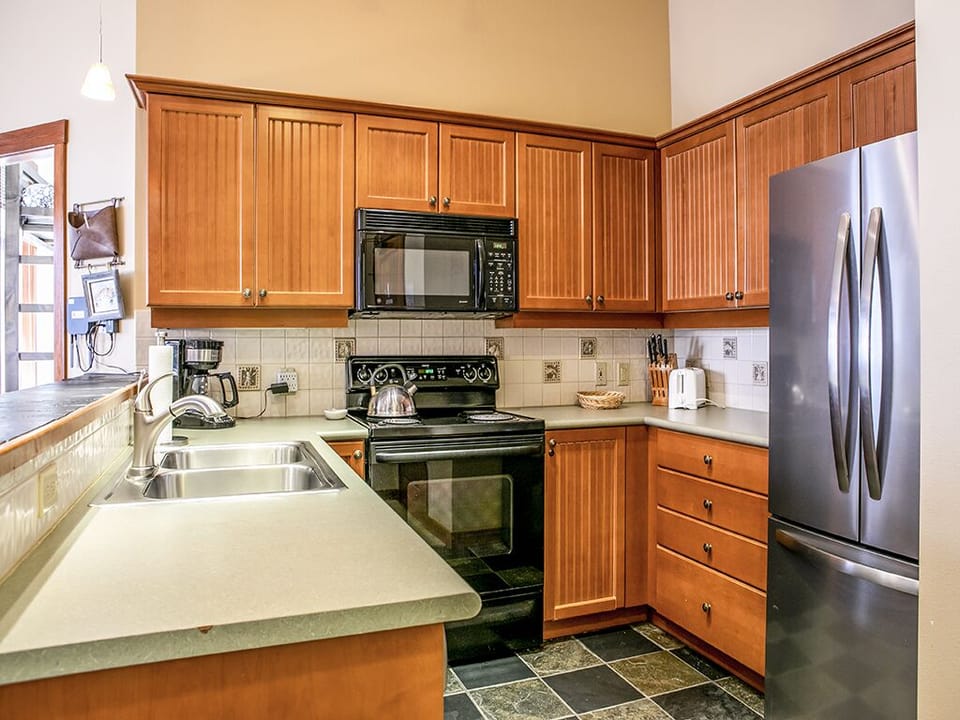 Kitchen - Kitchen with refrigerator, stove, microwave and sink.