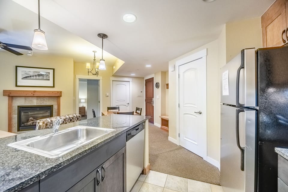 Kitchen - Granite counters, stainless steel appliances, and a variety of cooking utensils.