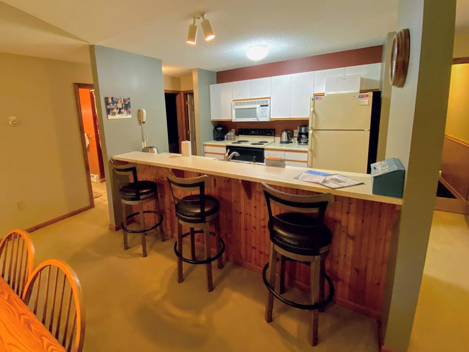 Fully stocked kitchen with a Keurig coffee maker and breakfast bar