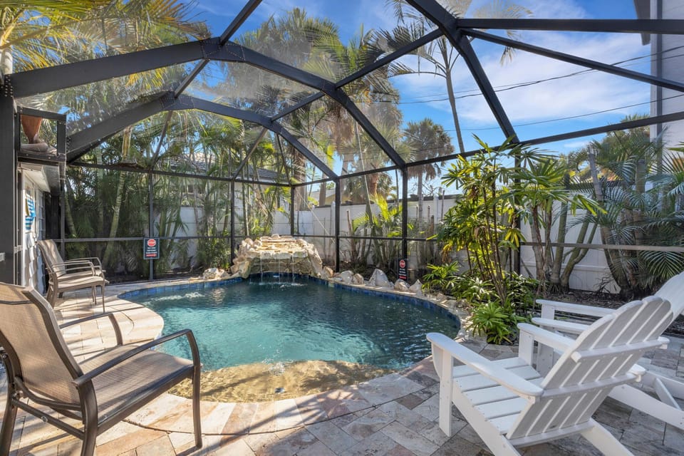 Private Screened Pool – A sparkling oasis with a waterfall feature, fully screened for comfort (Pool heat available for a fee)