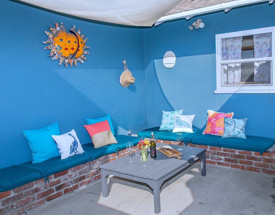 Relax on this inviting back patio with comfortable seating for six, ideal for meals, wine, or quiet moments. Whether reading, napping, or unwinding, this space offers a laid-back retreat.