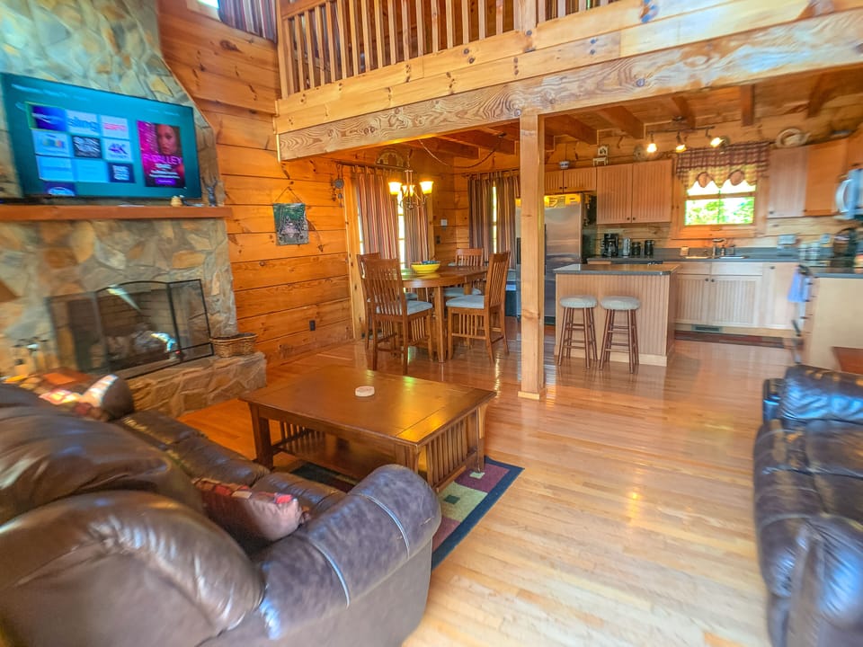 Comfy leather furniture, flatscreen TV and gas logs make this a perfect living area for your mountain vacation.
