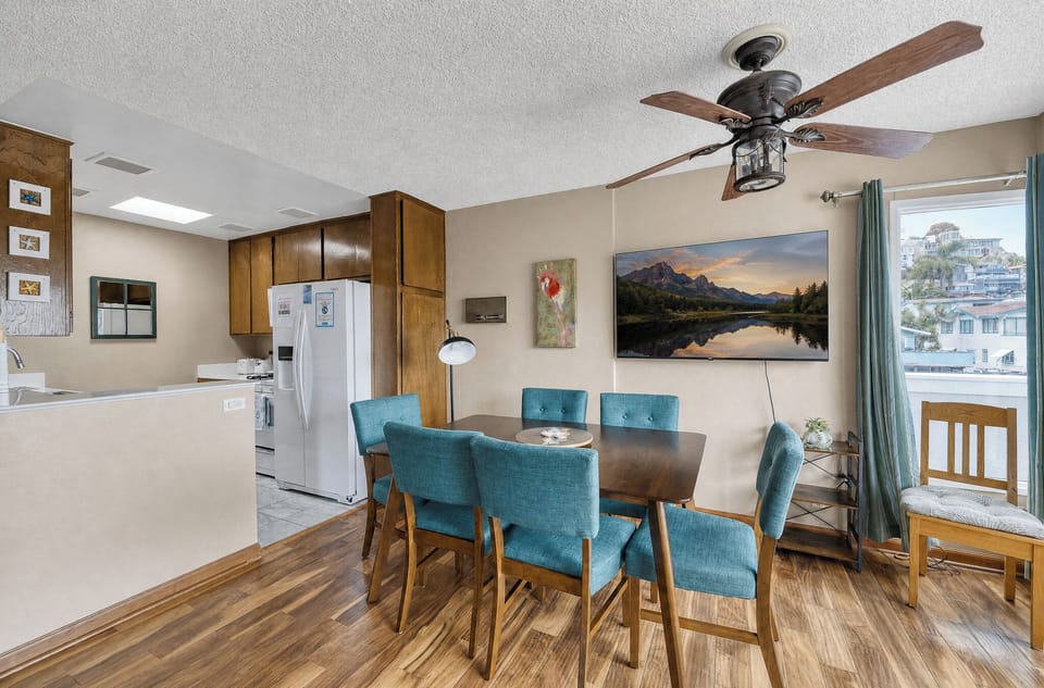 Gather around your dining table for six and enjoy meals together in this warm, open space that flows seamlessly into the kitchen.