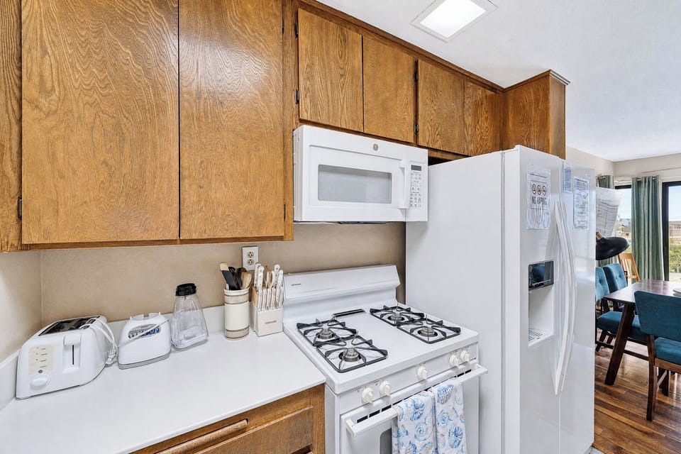 Your fully-equipped kitchen features warm wood cabinetry, full-sized appliances, and everything you need to prepare meals during your stay.