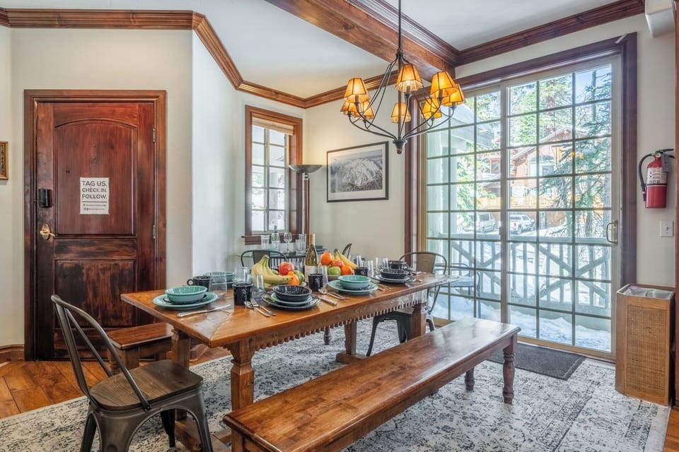 Dining area filled with natural light from the large sliding window, opening to a Juliet balcony, with a tucked-away table ideal for casual dining or a dedicated workspace.