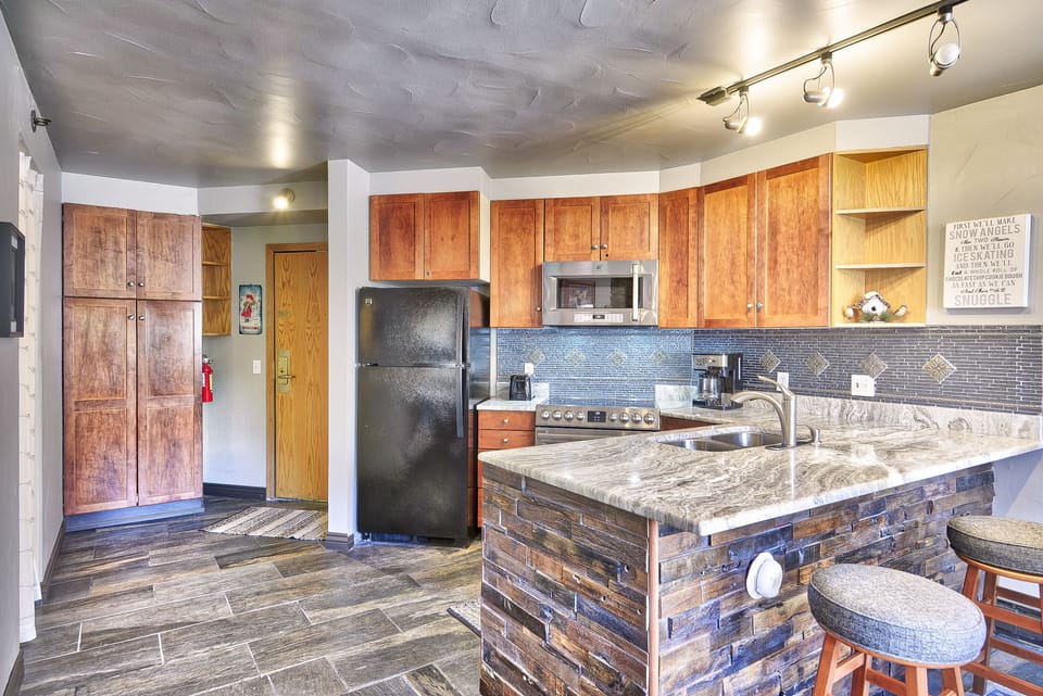 Kitchen - Features double sink, full size appliances, coffee maker, toaster, and more.