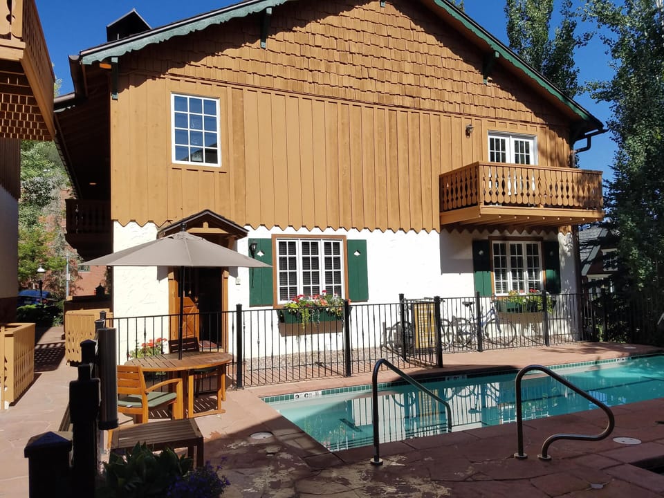 Frontal view of Alpenblick #4 showing the semi-private pool, Jacuzzi and grill. 