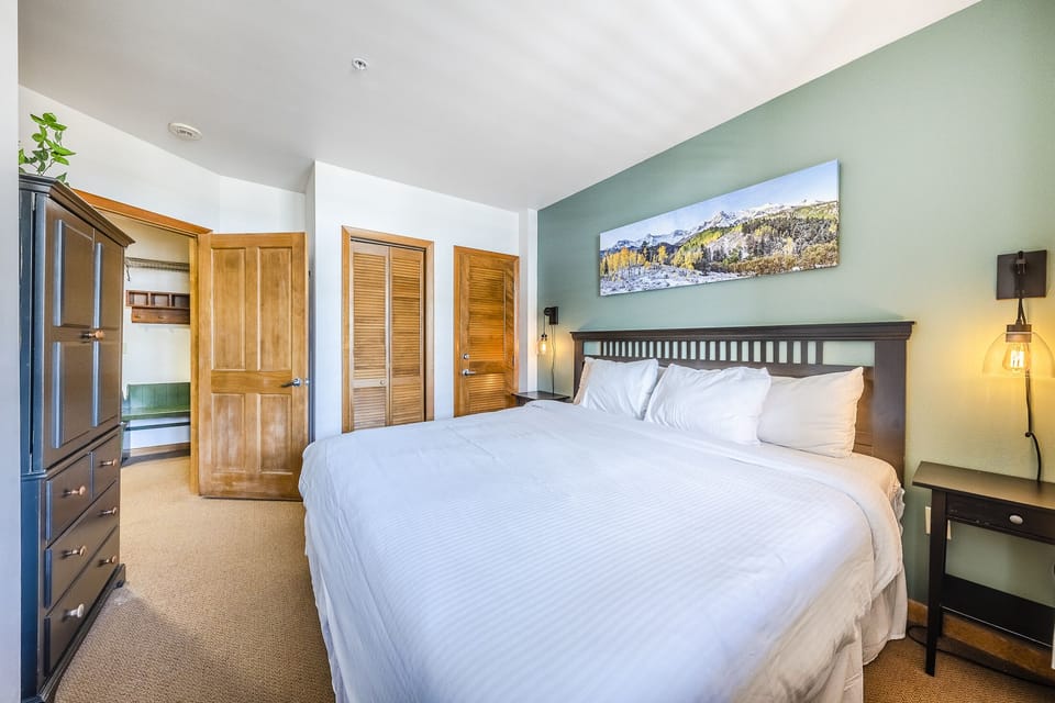 Primary Bedroom - King size bed, and flat screen TV in the armoire.

This property uses the Triple Sheet Method where we use two sheets to encase the comforter.  This sheet-made duvet cover gets washed between each and every guest to provide an extra clean sleeping experience.