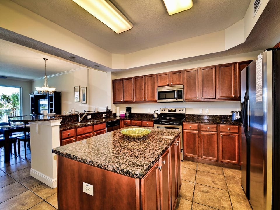 Kitchen has granite counter-tops and stainless steel appliances.