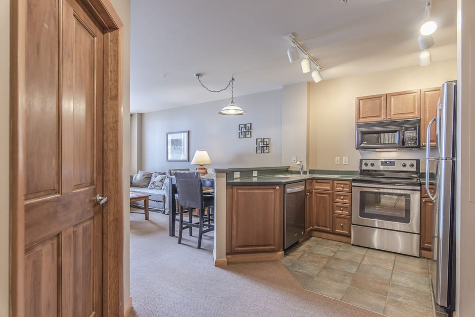 Kitchen - Full size stainless steel appliances.