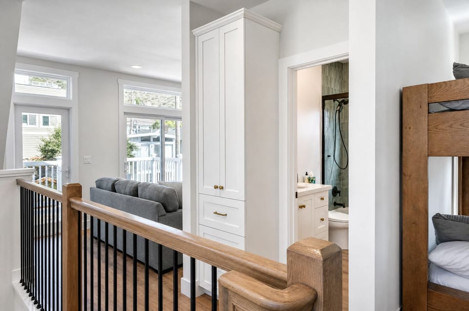 Step into a bright upstairs landing with custom built-in storage, cozy seating nook, and convenient en-suite access—where comfort and thoughtful design meet your every need.