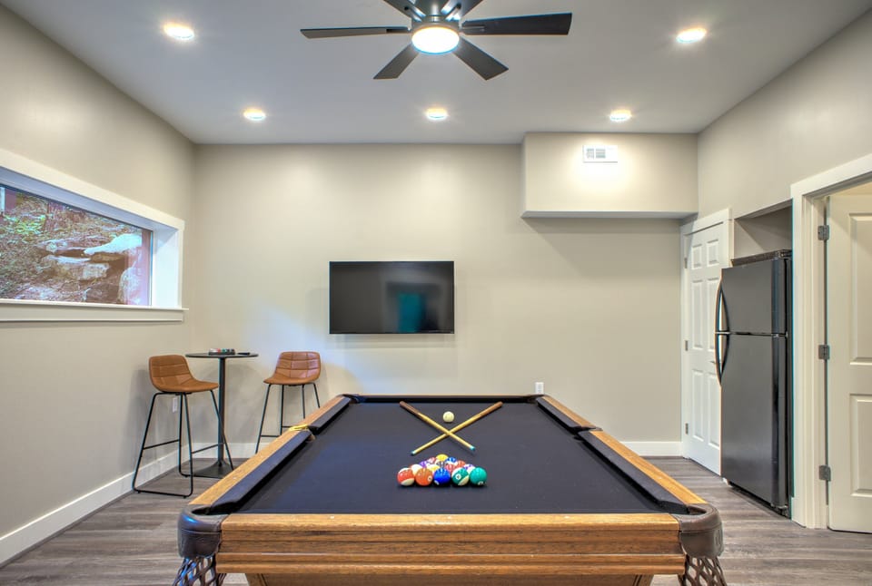 Game room with pool table with tv and extra fridge